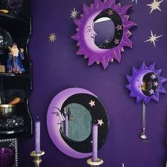 the purple wall is decorated with stars and moon decorations