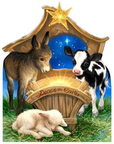 two baby animals are standing in front of a nativity scene