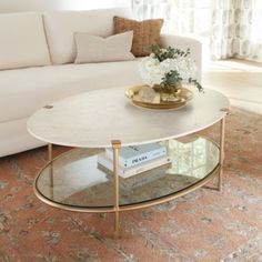 a living room with a white couch and coffee table