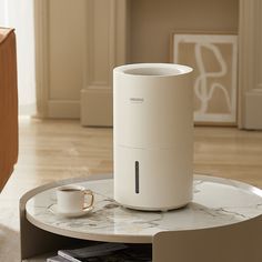 an air purifier sitting on top of a coffee table