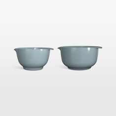 two bowls sitting next to each other on a white surface