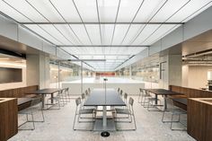 an empty conference room with tables and chairs