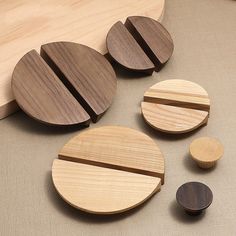 three wooden coasters sitting next to each other on top of a table with wood circles around them