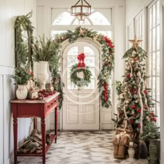 christmas decorations and wreaths are on display in the entryway