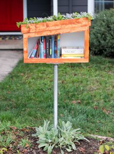 a bookshelf made out of an old bookcase is sitting in the grass