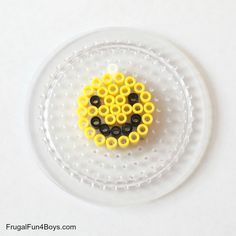 a plastic plate with yellow and black beads on it