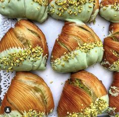 several croissants with green frosting and sprinkles on them