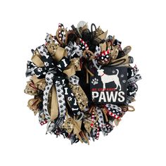 a dog themed wreath with the words paws on it