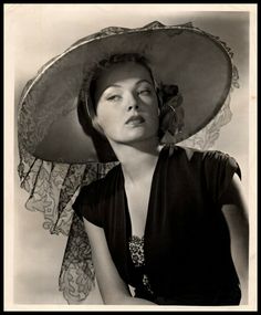 black and white photograph of a woman wearing a large hat