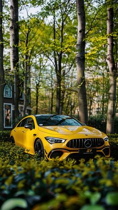 a yellow sports car is parked in the middle of some bushes and trees near a house