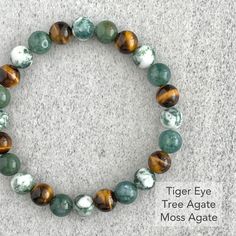 Men's beaded bracelet features: ~ 6mm, 8mm or 10mm tree agate beads ~ 6mm, 8mm or 10mm moss agate beads ~ 6mm, 8mm or 10mm yellow tiger eye or wood jasper beads ~ Stretchy cord; simply slide bracelet on and off wrist ~ Comes packaged in a re-usable microfiber pouch To ensure the perfect fit, please use the bracelet sizing instructions found in the photo gallery. Masculine Crystal Jewelry, Bracket Ideas, So Make The Friendship Bracelets, Make The Friendship Bracelets, Jasper Bead Bracelet, Beaded Jewelry Ideas, Slide Bracelet, Wood Bead Bracelet, High End Jewelry