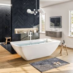 a large white bath tub sitting on top of a hard wood floor