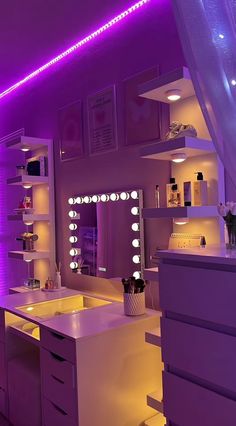 a bathroom with purple lighting in the ceiling and white counter tops on either side of the sink