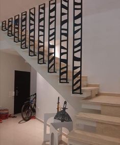 there is a bike parked on the floor next to some stairs in this room with white walls