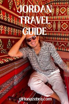 the jordan travel guide is on display in front of a red wall with an image of a