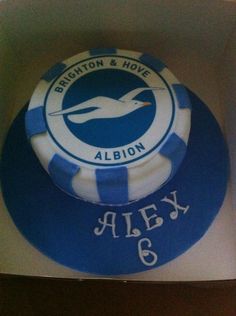 a blue and white cake with the words brighton & hover alix on it