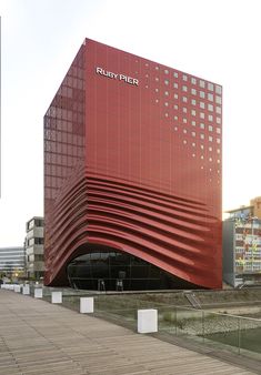 a large red building sitting next to a body of water