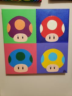 four different colored paintings on a white wall in the shape of mushroom's faces