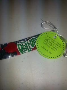 a candy bar with a tag attached to it sitting on a white counter top next to a green sticker