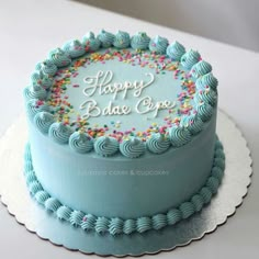 a birthday cake with blue frosting and sprinkles