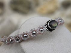 a beaded bracelet with beads and a stone