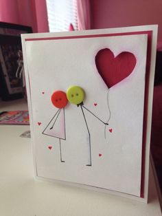 a card with two people holding hands and a heart shaped balloon attached to the back