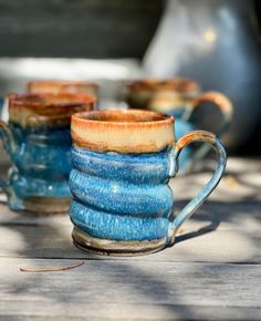 three blue mugs stacked on top of each other