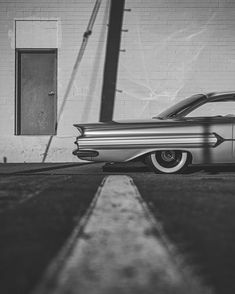 an old car parked in front of a building