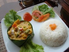 a white plate topped with rice and veggies