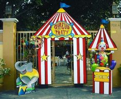 a carnival tent with clowns and circus signs on the front entrance to an amusement park