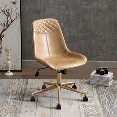 a tan office chair sitting on top of a wooden floor next to a white rug