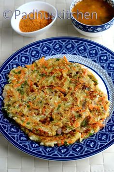 a blue plate topped with an omelet next to two bowls of seasoning