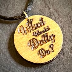 This stunning Dolly Parton pendant necklace is a must-have for any dolly lover. The round 1 inch wood charm is engraved in detail. The necklace features a satin adjustable cord. The pendant shape and setting style are unique and eye-catching, while the black satin cord adds a touch of casual elegance. Don't miss out on the chance to add this unbranded charm necklace to your jewelry collection. Note; wood grain and tint may differ. Engraved Pendant, Bear Paws, Metal Engraving, Engraved Wood, Dolly Parton, Engraved Necklace, Cord Bracelets, Cord Necklace, Oklahoma City