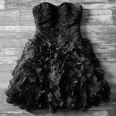 black and white photograph of dress on wooden floor