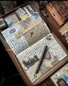 an open book with writing on it sitting on a table next to other books and papers