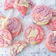 several pink and white cookies are on a piece of paper