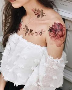 a woman with flowers on her shoulder and chest