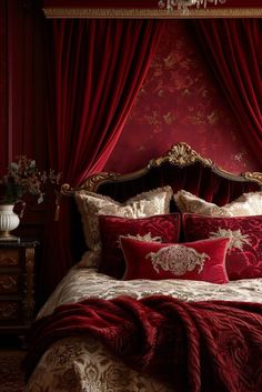 a bed with red and gold comforters in front of a red curtained window