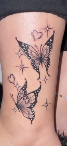 a woman's back with two butterflies on her lower body and stars in the background