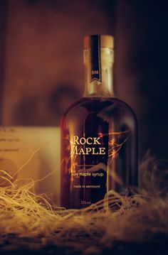 a bottle of rock maple syrup sitting on top of a table