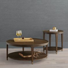 two tables with wine glasses on them and a tray in front of the coffee table