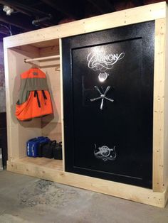 a coat rack with an orange life jacket hanging from it's side and some other items in the back