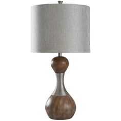 a table lamp with a wooden base and grey shade on the top, sitting on a white background