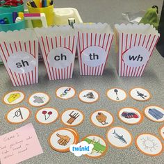 some paper bags that are sitting on the floor with different things in them, including letters and numbers