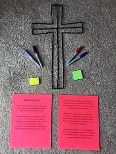 two pieces of paper with markers and pens on them next to a cross made out of sticky notes