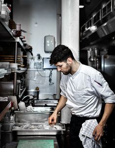 a man standing in a kitchen preparing food