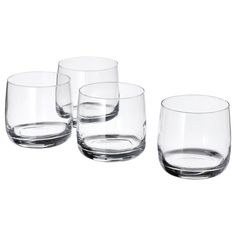 four clear glass cups sitting next to each other