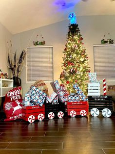 a christmas tree is surrounded by boxes and presents