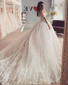 Look stunning on your wedding day in this Charming Long Sleeves Tulle Ball Gown Wedding Dress. Crafted from tulle with an A-line silhouette, this dress features a jewel neckline with detailed lace embellished long sleeves and a zipper back. The natural waistline and court train provide a perfect fit and flatter all body shapes. Perfect for any season. Gown Ideas, Long Sleeve Ball Gowns, Disney Jasmine, A Wedding Dress, Wedding Dress Trends, Princess Wedding, Popular Wedding, Tulle Wedding, Online Wedding Dress