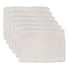 six white napkins with frayed edges